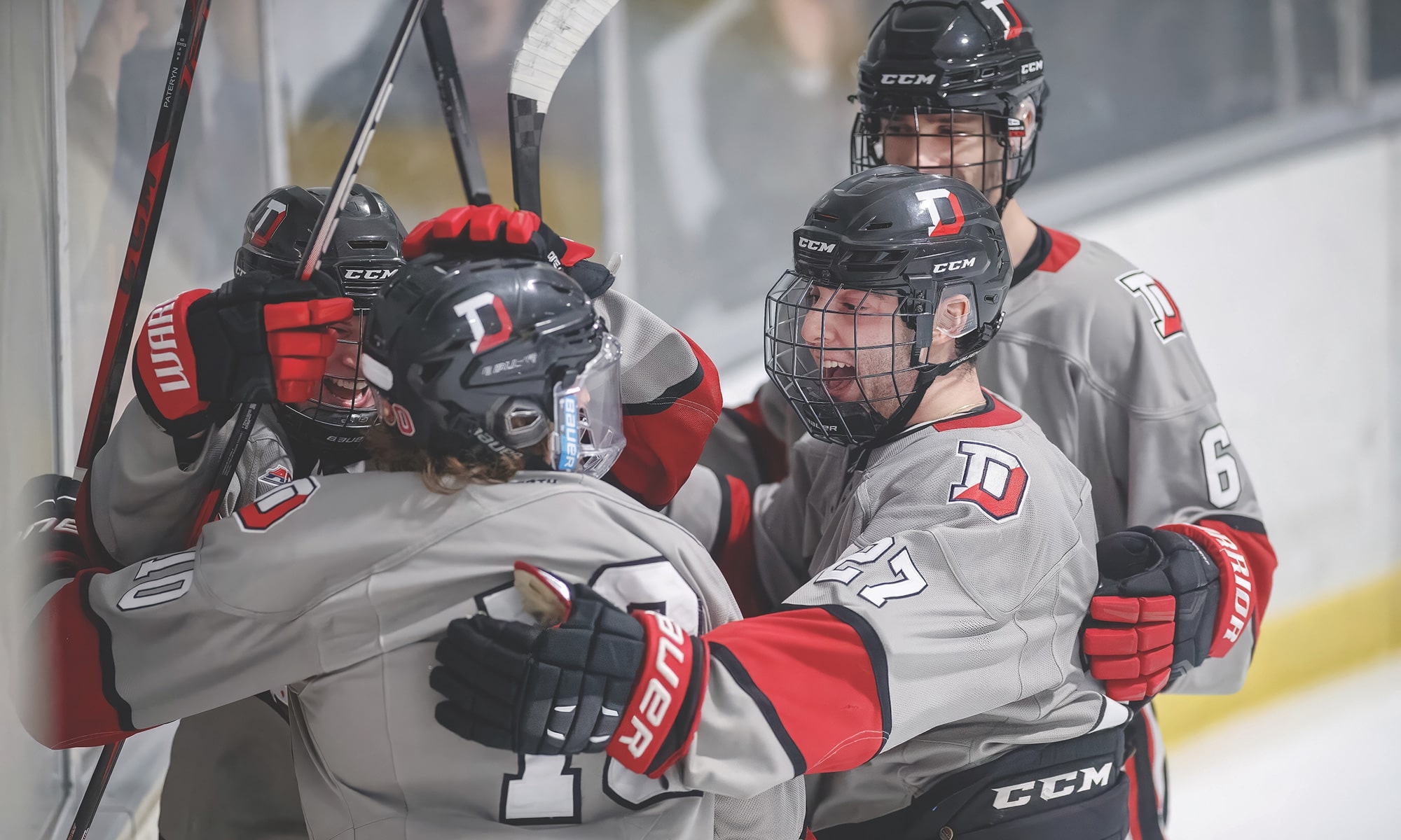 Denison hockey players embracing