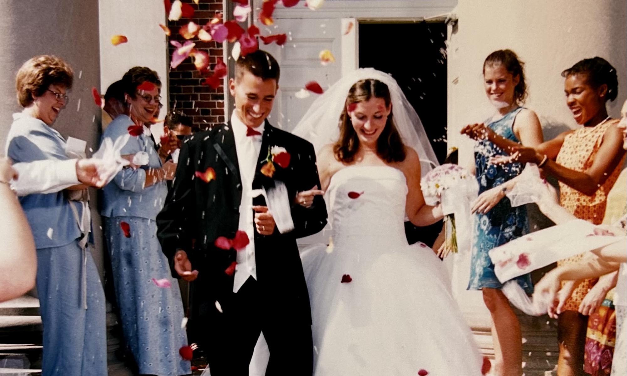 Andy and Hannah Boyd exiting Swasey Chapel on the wedding day, showered in flower petals.