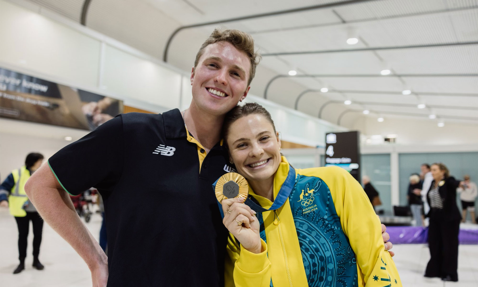 James Baker greeted Olympic pole vault champion Nina Kennedy at the airport in Perth, Australia after she returned from Paris. 