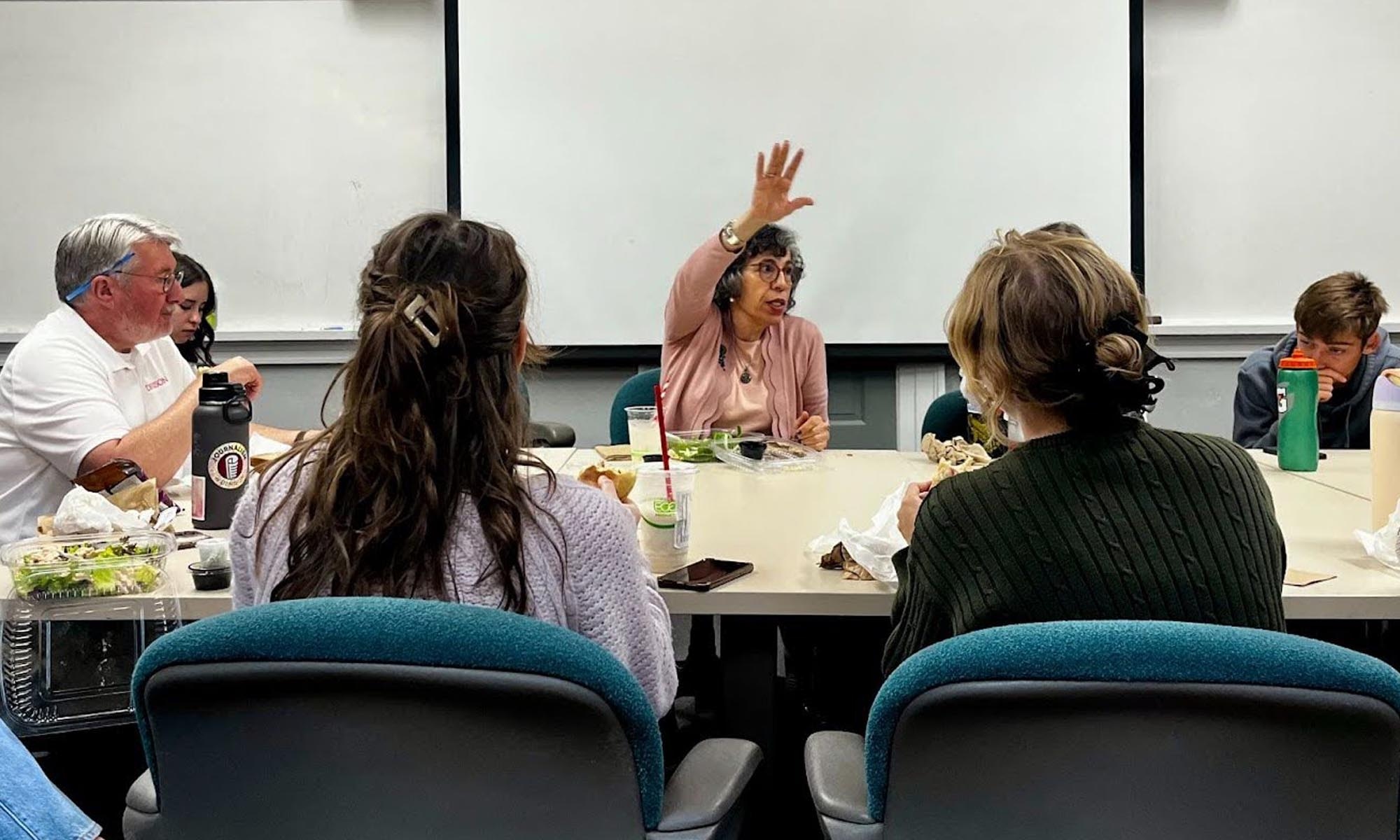 Anne Saker (center) meets with Denison journalism students over lunch.