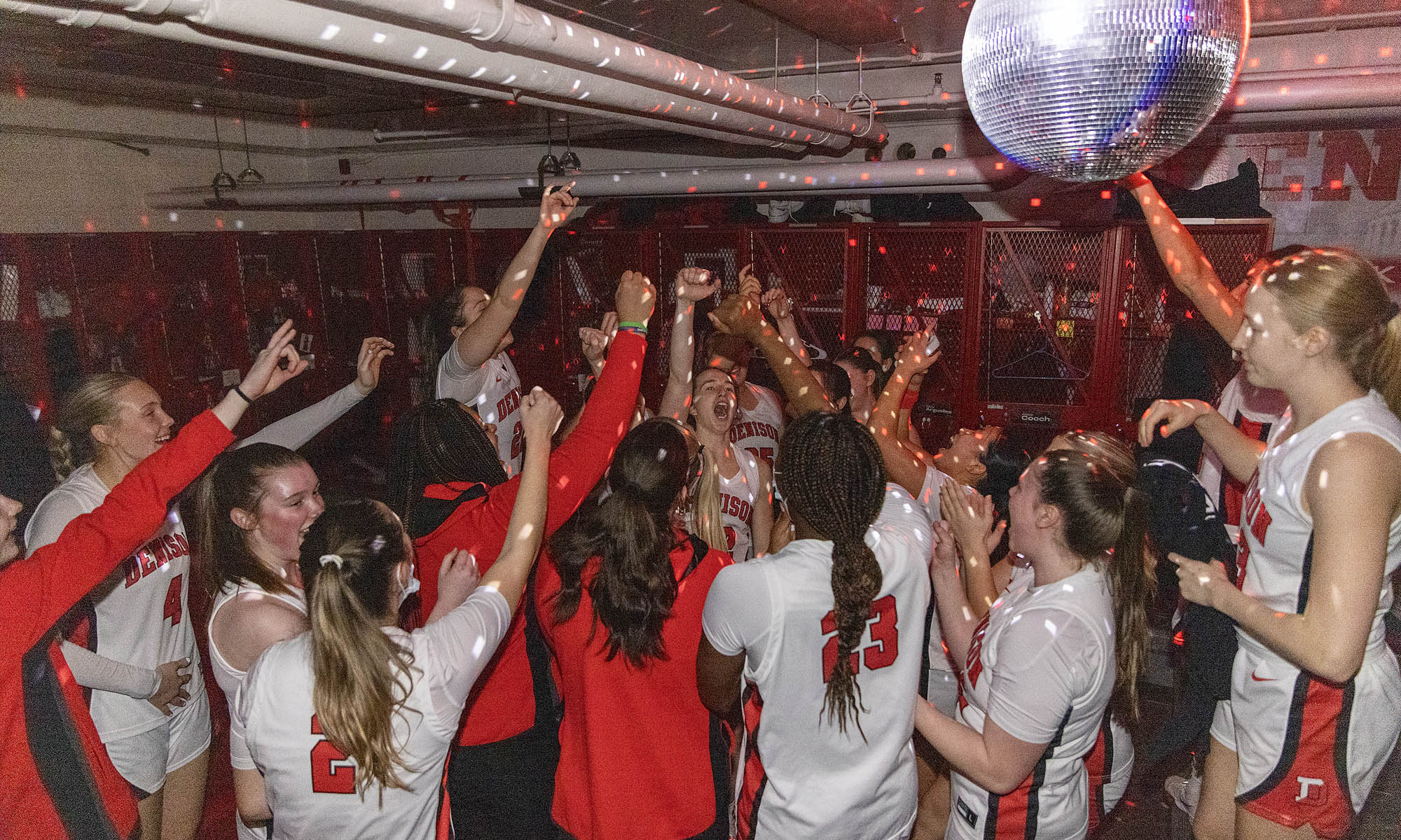 Denison Women's Basketball team under the disco ball before tipoff.