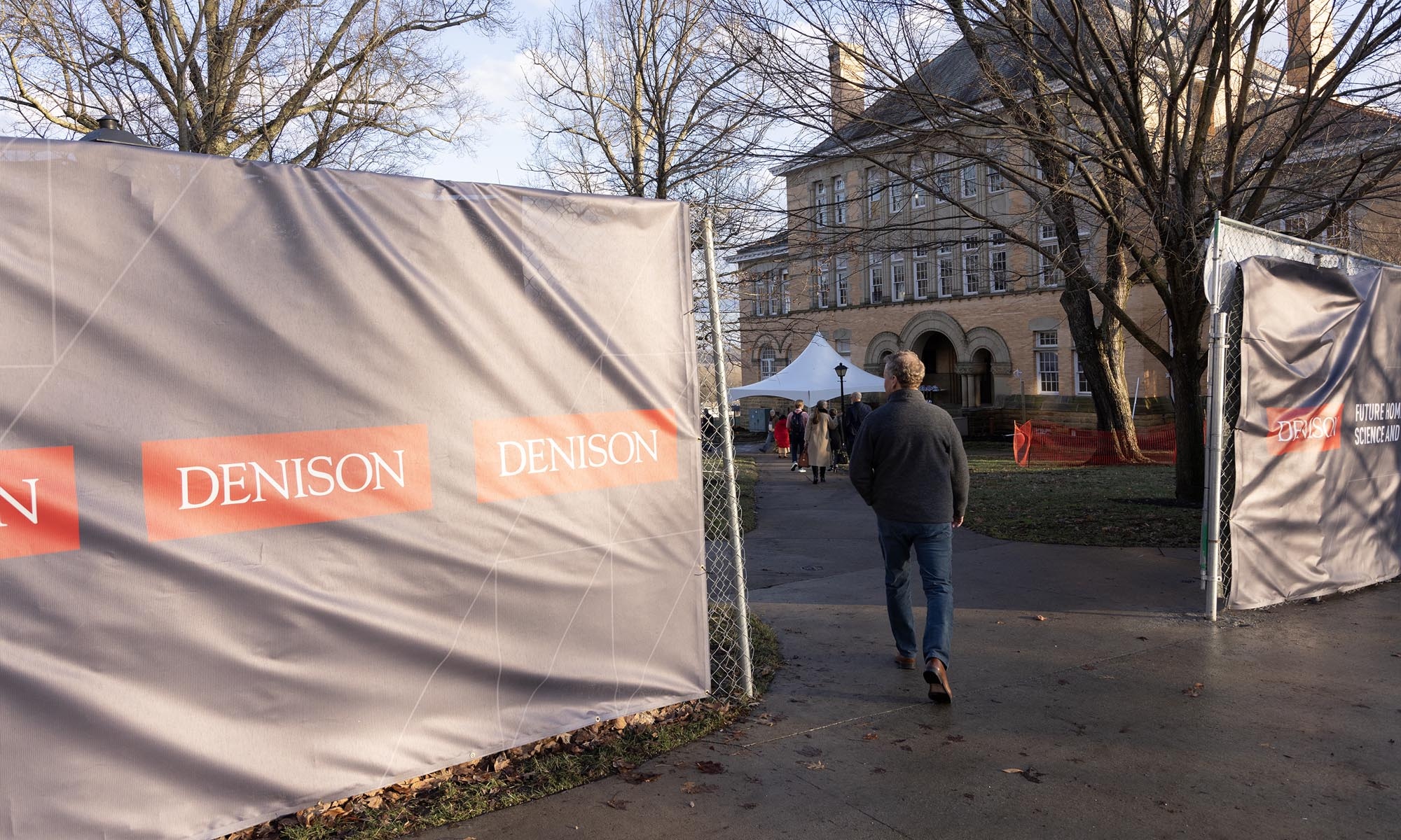 A view of Doane Hall seen through an opening in the Denison-branded construction fence that will surround the building during the renovation.